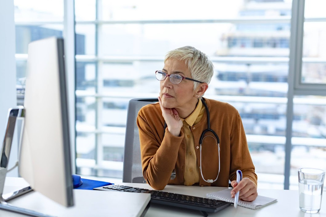 Female doctor searching online on her computer.