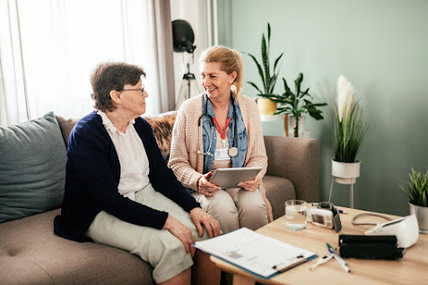 Health professional sitting and talking with patient.