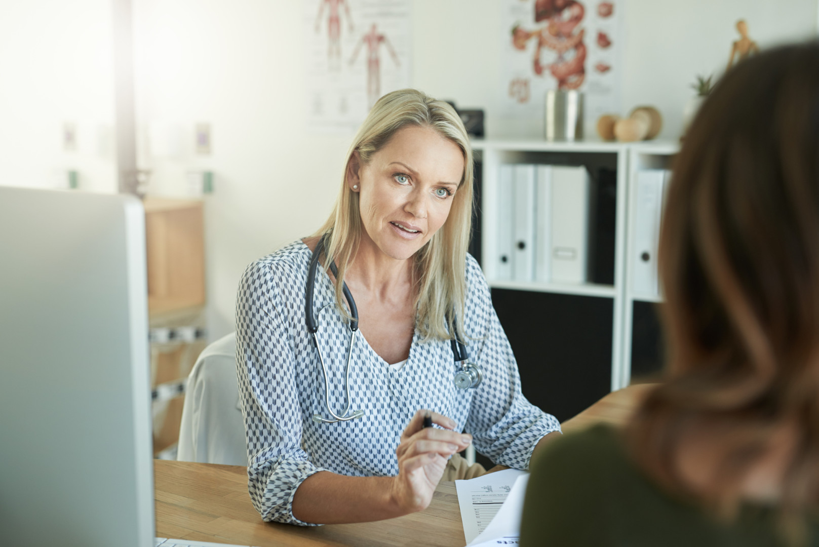 Female GP talking with patient.