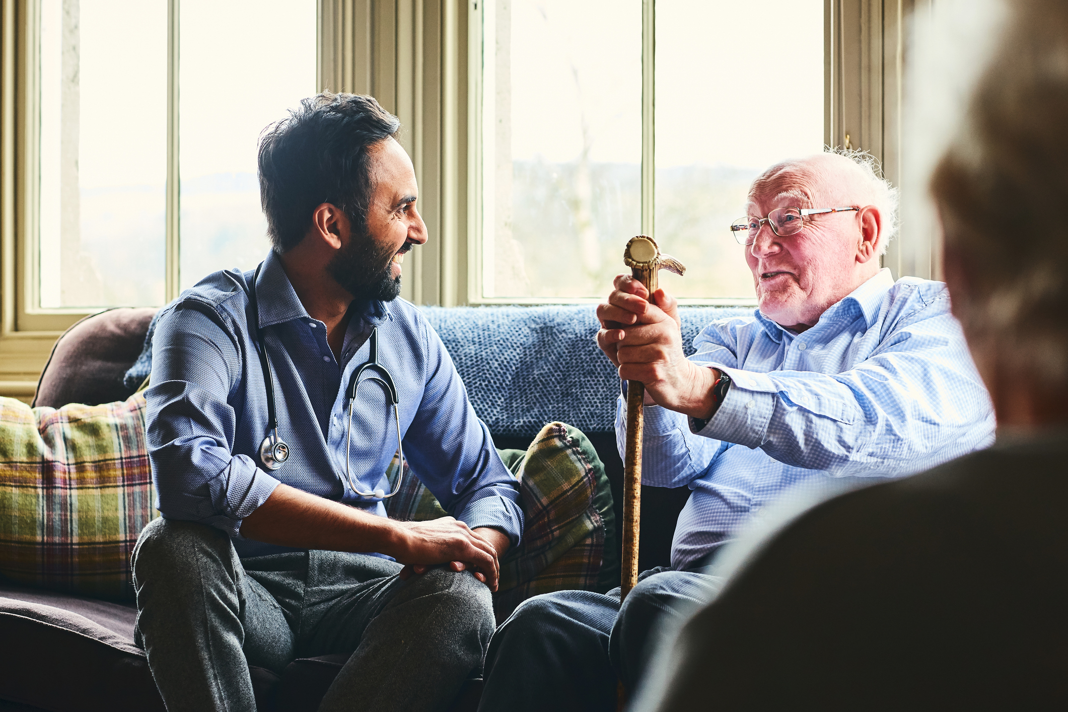 GP speaking happily with an elderly man